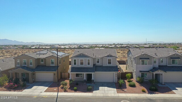 view of front of house with a garage and a mountain view