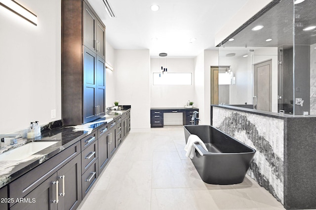 bathroom featuring double vanity, a soaking tub, recessed lighting, and a sink