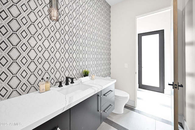 bathroom featuring toilet, vanity, and tile patterned flooring