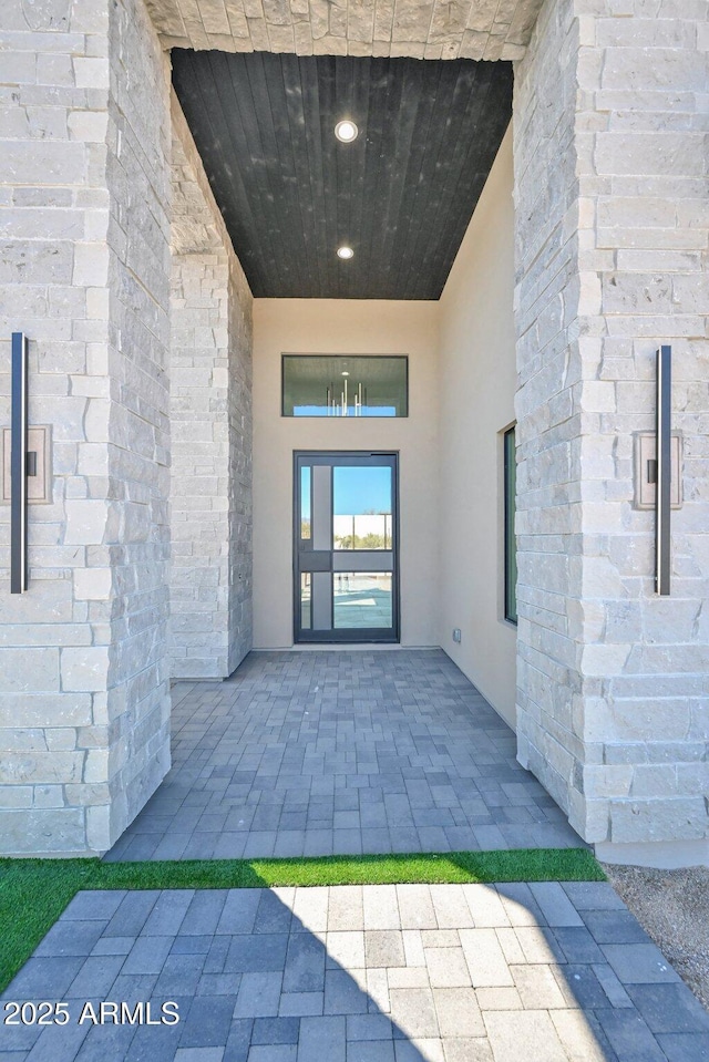 doorway to property featuring stucco siding