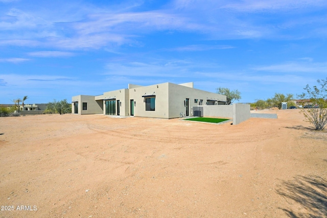 back of property featuring stucco siding