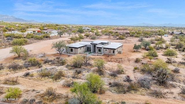 aerial view with a mountain view, a rural view, and a desert view