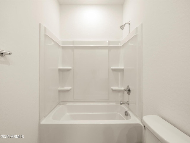 bathroom with tub / shower combination and toilet