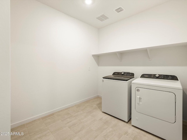 clothes washing area with washer and dryer