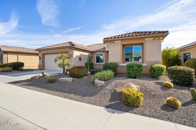 mediterranean / spanish-style home with a garage