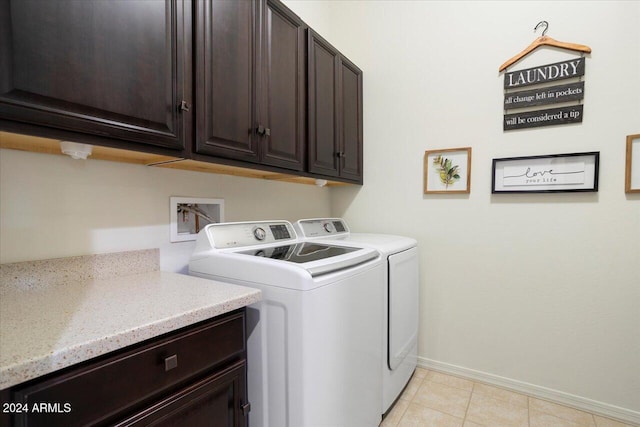 laundry room with light tile patterned flooring, cabinets, and independent washer and dryer