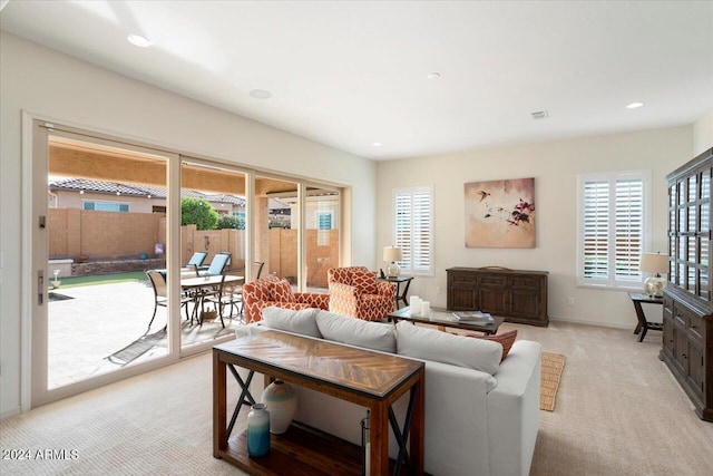 carpeted living room featuring plenty of natural light