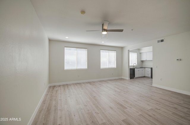 615 E Portland St Unit 261, Phoenix, AZ 85004 - unfurnished living room with a ceiling fan and light wood-type flooring