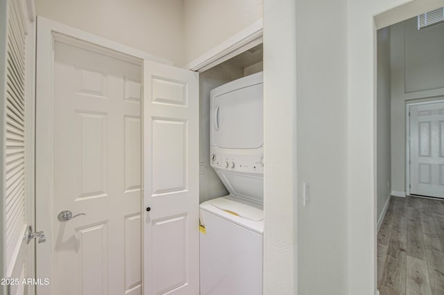 615 E Portland St Unit 261, Phoenix, AZ 85004 - laundry area featuring stacked washing machine and dryer and wood finished floors