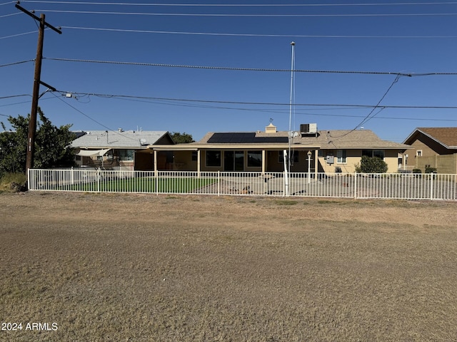 view of front of property featuring solar panels