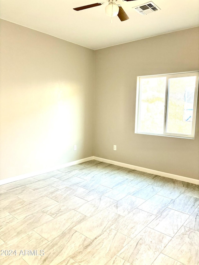 spare room with ceiling fan