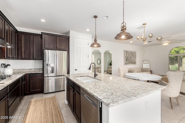 3910 E Turley St, Gilbert, AZ 85295 - kitchen featuring appliances with stainless steel finishes, a sink, arched walkways, light tile patterned flooring, and open floor plan
