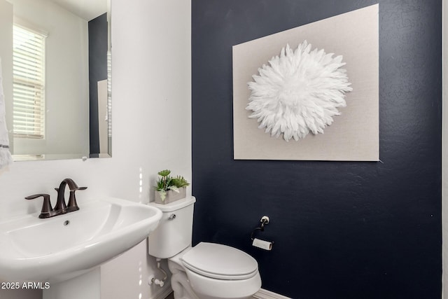 3910 E Turley St, Gilbert, AZ 85295 - half bathroom with a sink, toilet, and baseboards