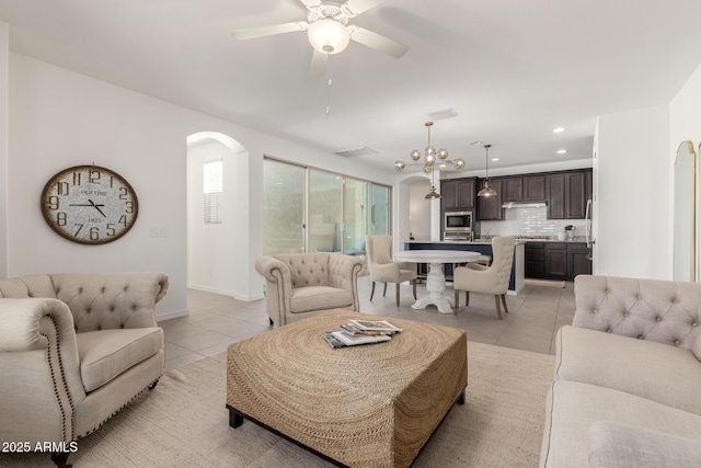 3910 E Turley St, Gilbert, AZ 85295 - living room featuring light tile patterned floors, arched walkways, a ceiling fan, recessed lighting, and baseboards