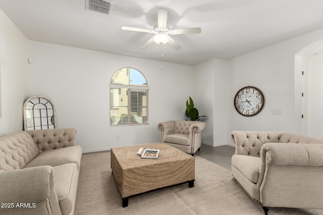 3910 E Turley St, Gilbert, AZ 85295 - living room featuring arched walkways, a ceiling fan, and baseboards