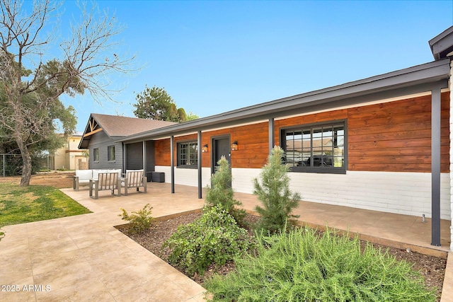 back of house with a patio