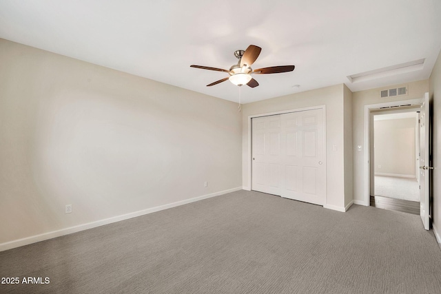 unfurnished bedroom featuring carpet floors, a closet, visible vents, and baseboards