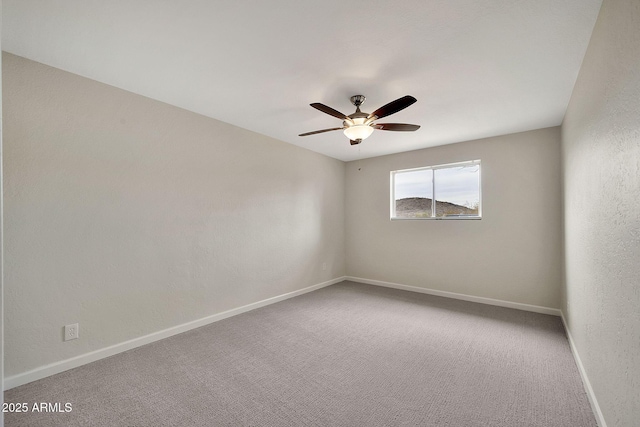 unfurnished room featuring carpet flooring, a ceiling fan, and baseboards