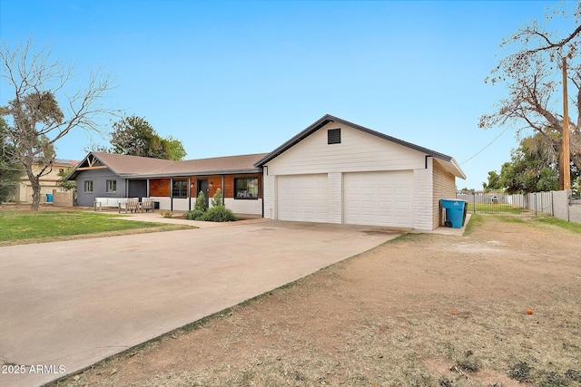 single story home featuring a garage, fence, concrete driveway, and brick siding