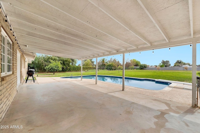 outdoor pool with a grill, a yard, and a patio