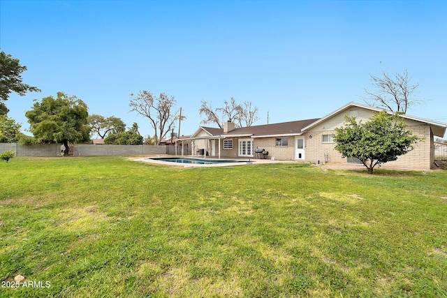 view of yard featuring a fenced in pool, a fenced backyard, and a patio