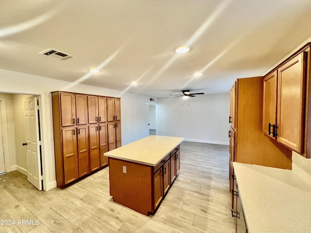 1737 N Trevor Dr, Mesa, AZ 85201 - kitchen with a kitchen island, ceiling fan, light countertops, recessed lighting, and brown cabinetry