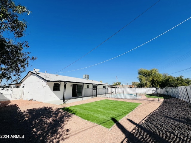 1737 N Trevor Dr, Mesa, AZ 85201 - rear view of property featuring a fenced backyard, a patio, and brick siding