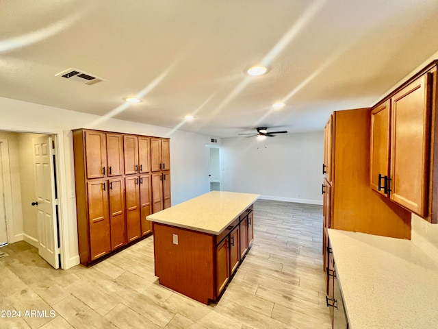 kitchen with a center island, light hardwood / wood-style floors, and ceiling fan