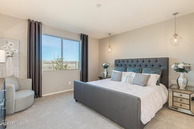 bedroom with light carpet and baseboards