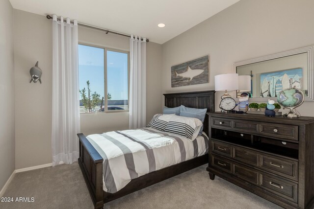 bedroom featuring light carpet and baseboards