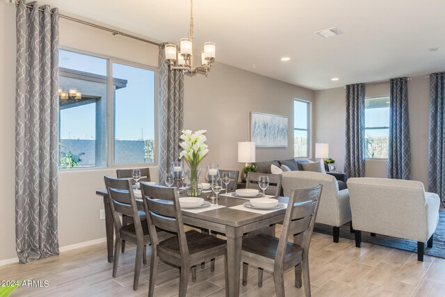 dining area featuring recessed lighting, visible vents, baseboards, wood tiled floor, and an inviting chandelier