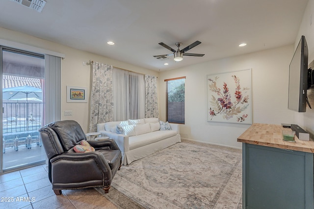living area featuring a ceiling fan, tile patterned floors, visible vents, and recessed lighting