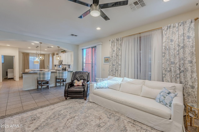 living room with visible vents, ceiling fan, recessed lighting, plenty of natural light, and light tile patterned floors