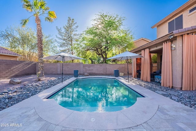 view of pool featuring a fenced backyard, a fenced in pool, and a patio area
