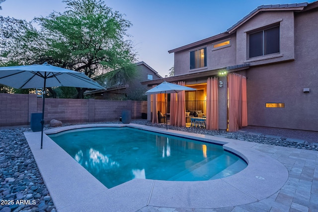 view of swimming pool featuring a fenced in pool, a fenced backyard, and a patio area