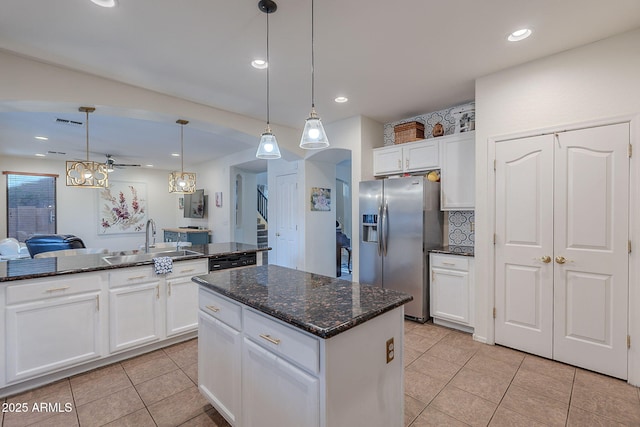 kitchen with a sink, stainless steel fridge with ice dispenser, light tile patterned floors, and a center island