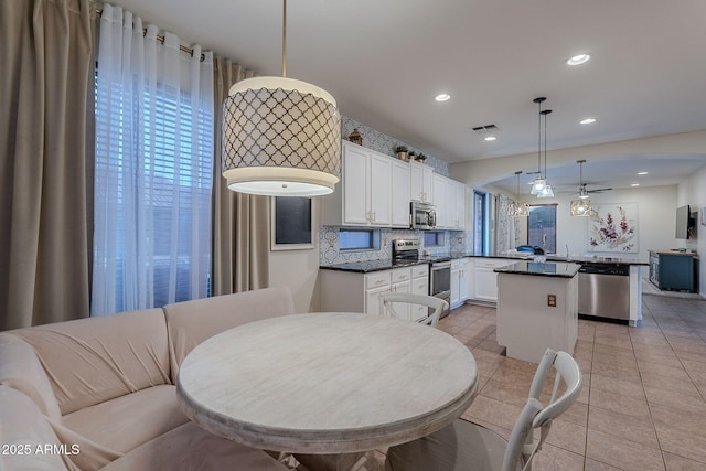 dining area with light tile patterned floors, ceiling fan, recessed lighting, and visible vents