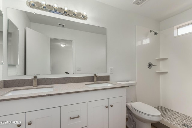 bathroom featuring a sink, visible vents, and toilet