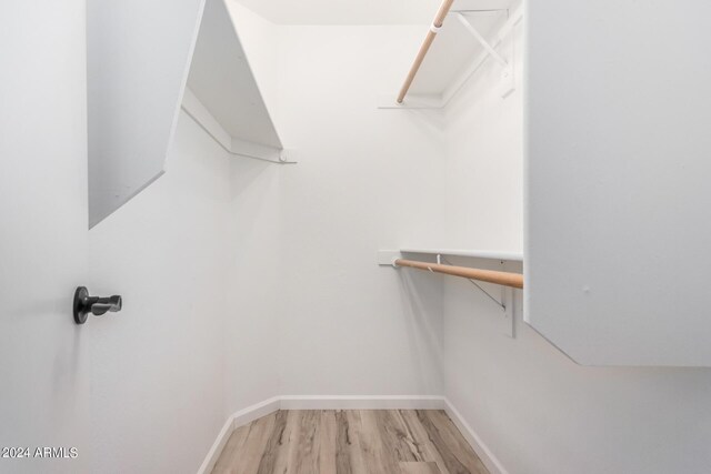 walk in closet featuring light hardwood / wood-style floors