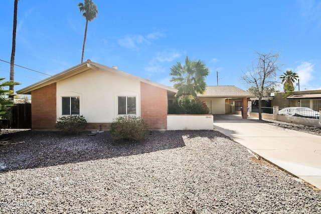 view of property exterior with fence and stucco siding