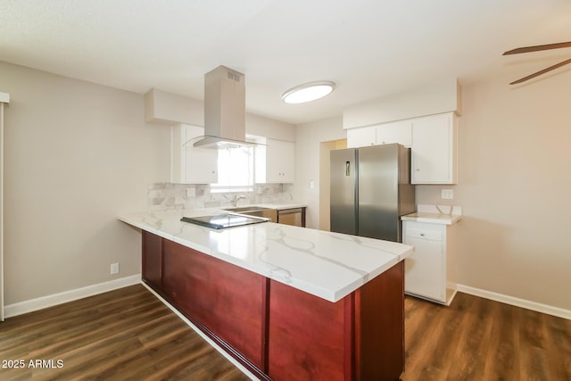 kitchen featuring light countertops, white cabinetry, freestanding refrigerator, and island range hood