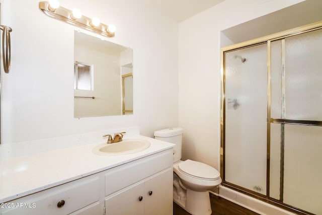 full bath with toilet, a stall shower, and vanity