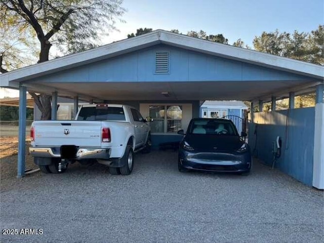 view of parking featuring driveway and a carport