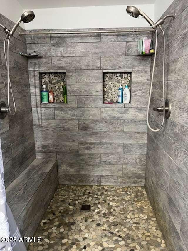 full bathroom with a tile shower