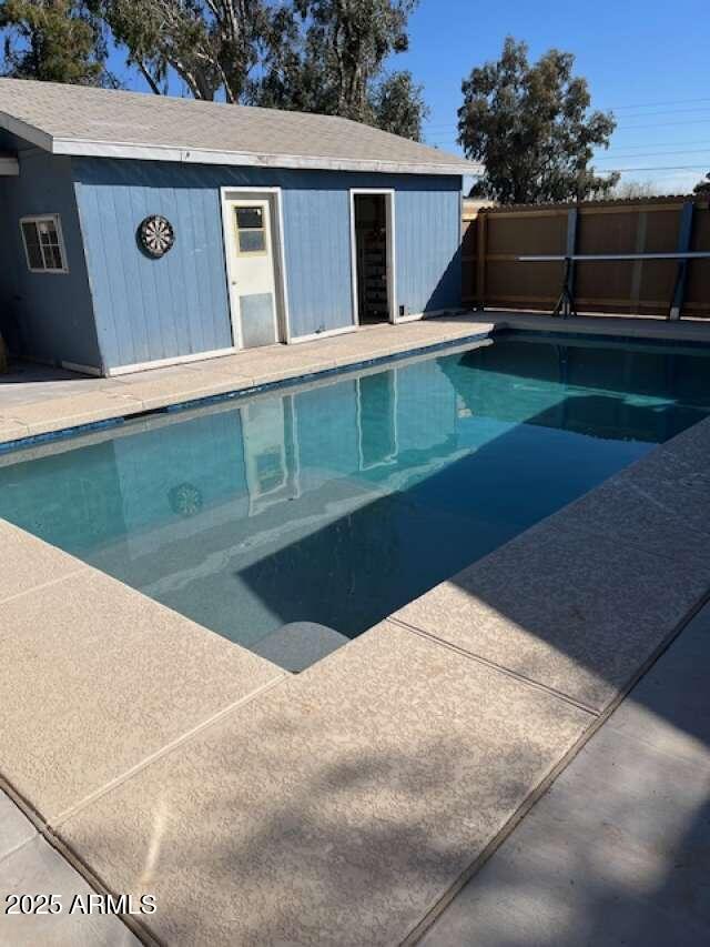 view of swimming pool with fence and a fenced in pool