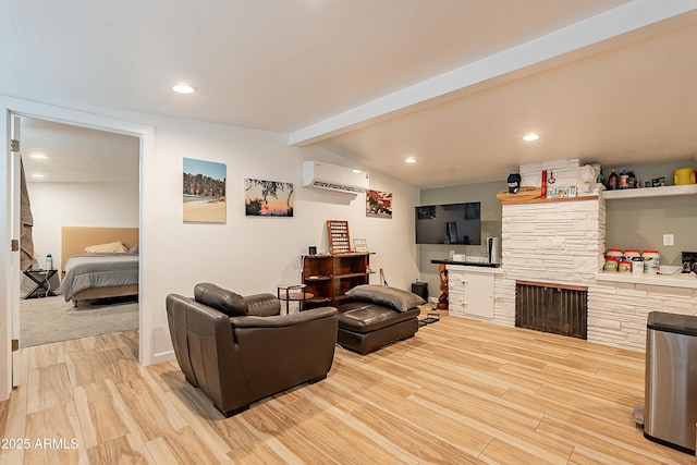 living room with vaulted ceiling with beams, a fireplace, a wall mounted AC, and light wood-type flooring