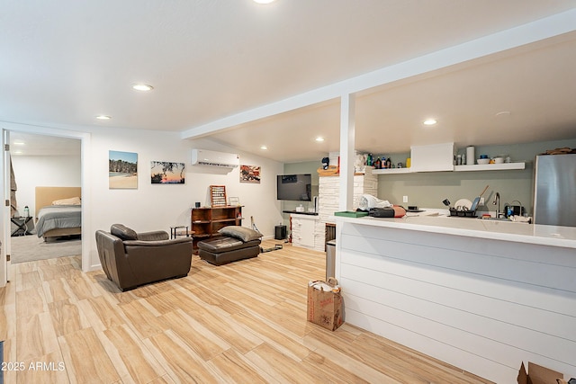 living room with lofted ceiling with beams, a wall unit AC, and light wood-type flooring