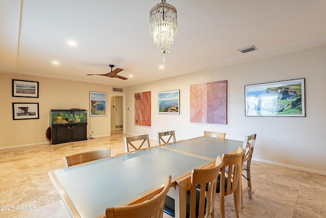 dining room featuring ceiling fan with notable chandelier