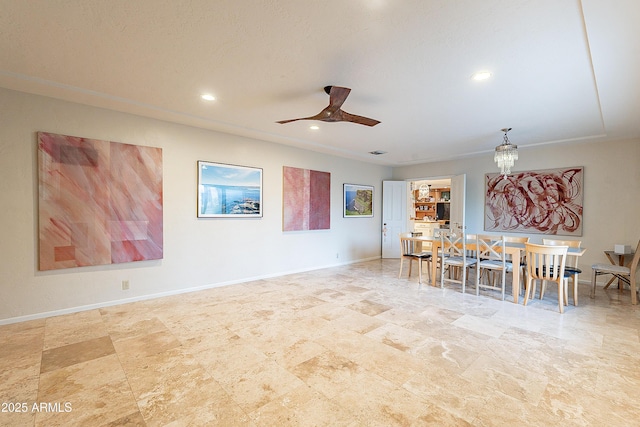 dining space with ceiling fan with notable chandelier