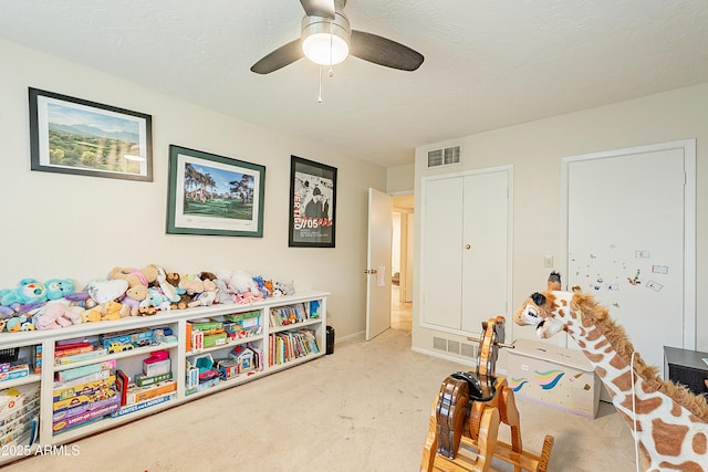 game room with light carpet and a textured ceiling